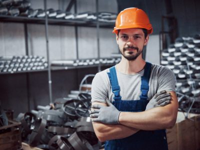 portrait-young-worker-hard-hat-large-metalworking-plant portrait-young-worker-hard-hat-large-metalworking-plant