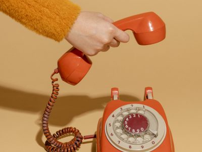 Woman answering an old retro telephone Woman answering an old retro telephone